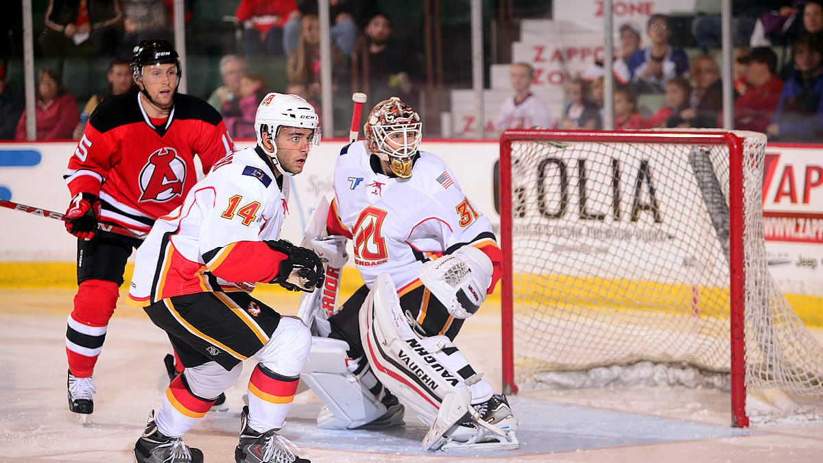 FLAMES DOWNED BY DEVILS IN HOME OPENER