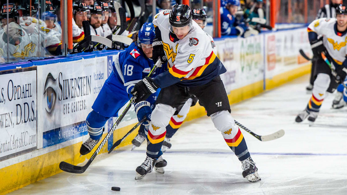 Ryan White battles for a puck on Friday night in KC
